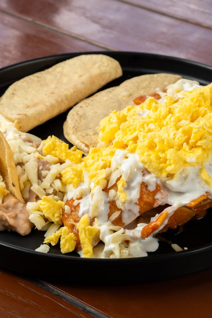 Mouth-watering Mexican breakfast platter featuring cheesy tacos and scrambled eggs, perfect for food photography.